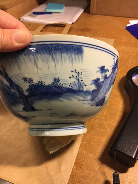 A BLUE AND WHITE BOWL.