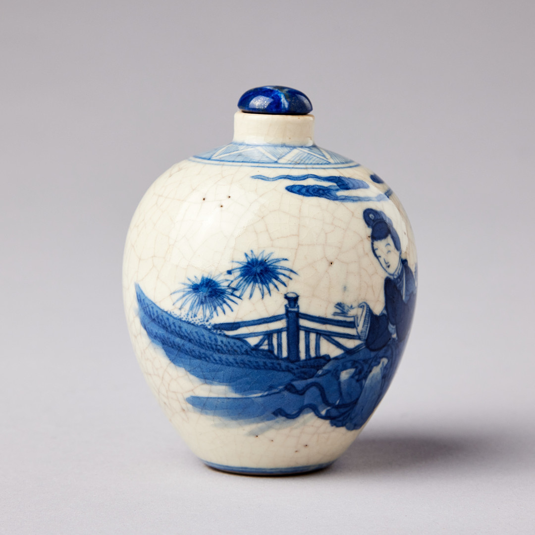 A SMALL BLUE AND WHITE BOTTLE.