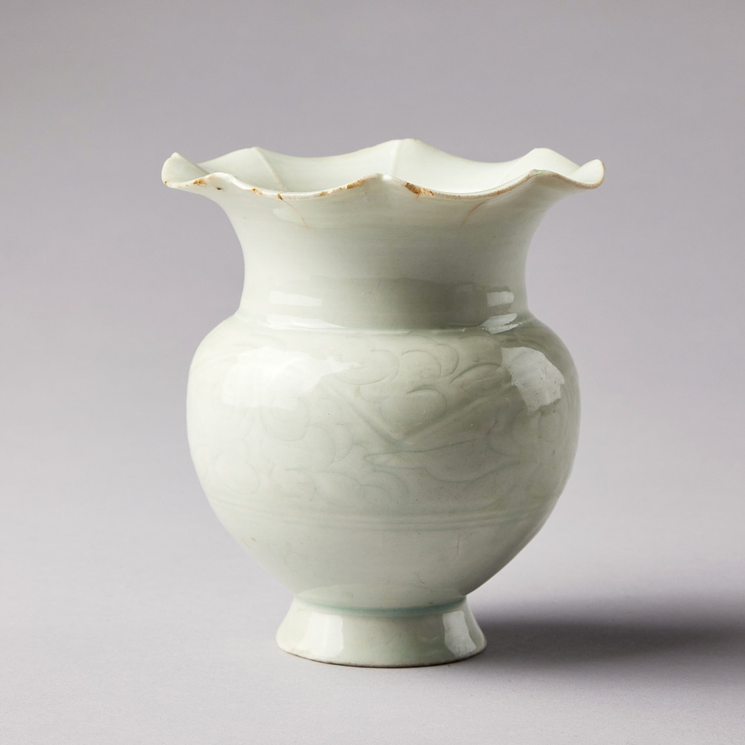 A QINGBAI CARVED BALUSTER VASE.