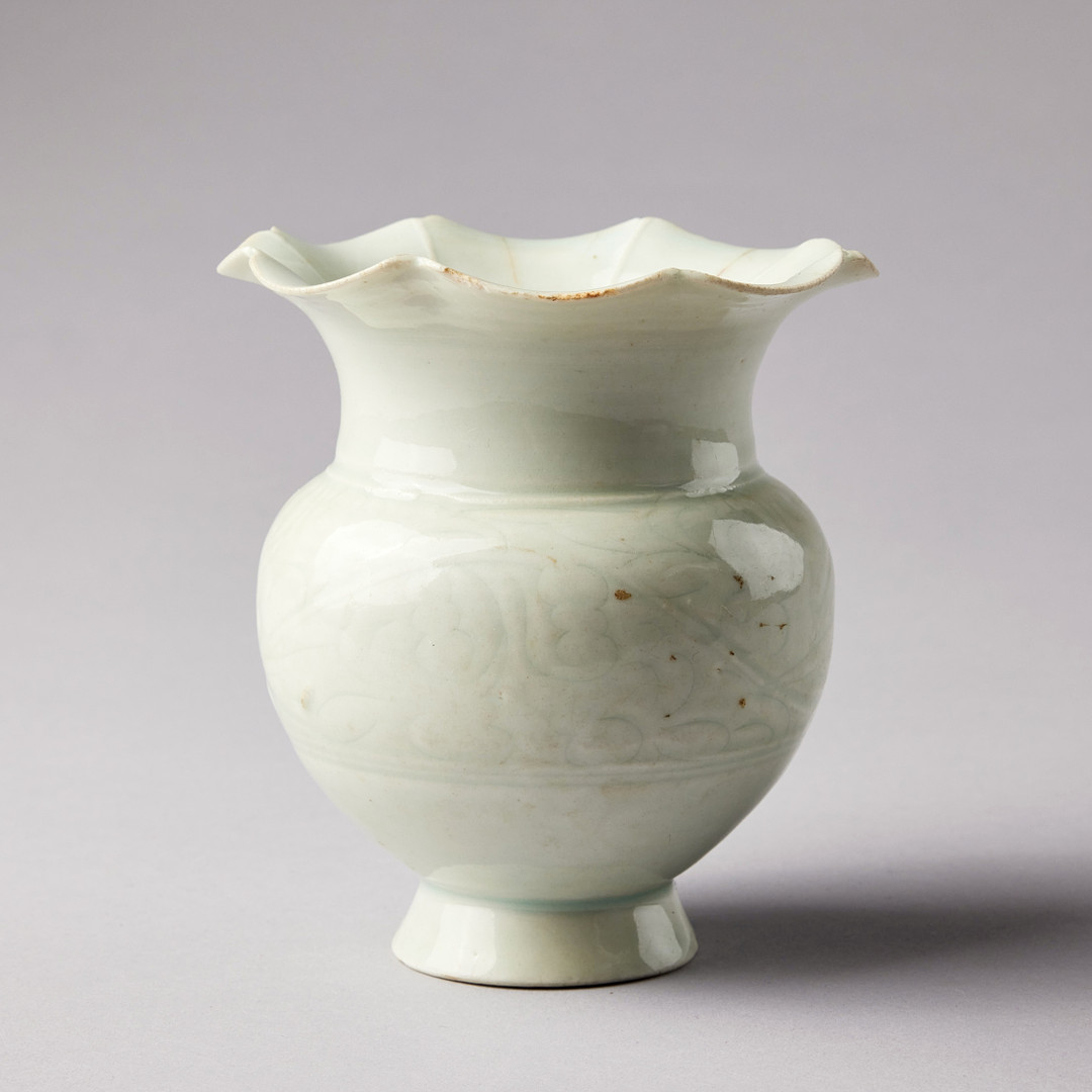 A QINGBAI CARVED BALUSTER VASE.