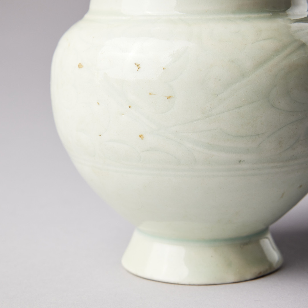 A QINGBAI CARVED BALUSTER VASE.