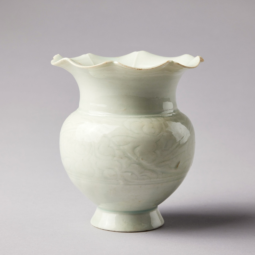 A QINGBAI CARVED BALUSTER VASE.