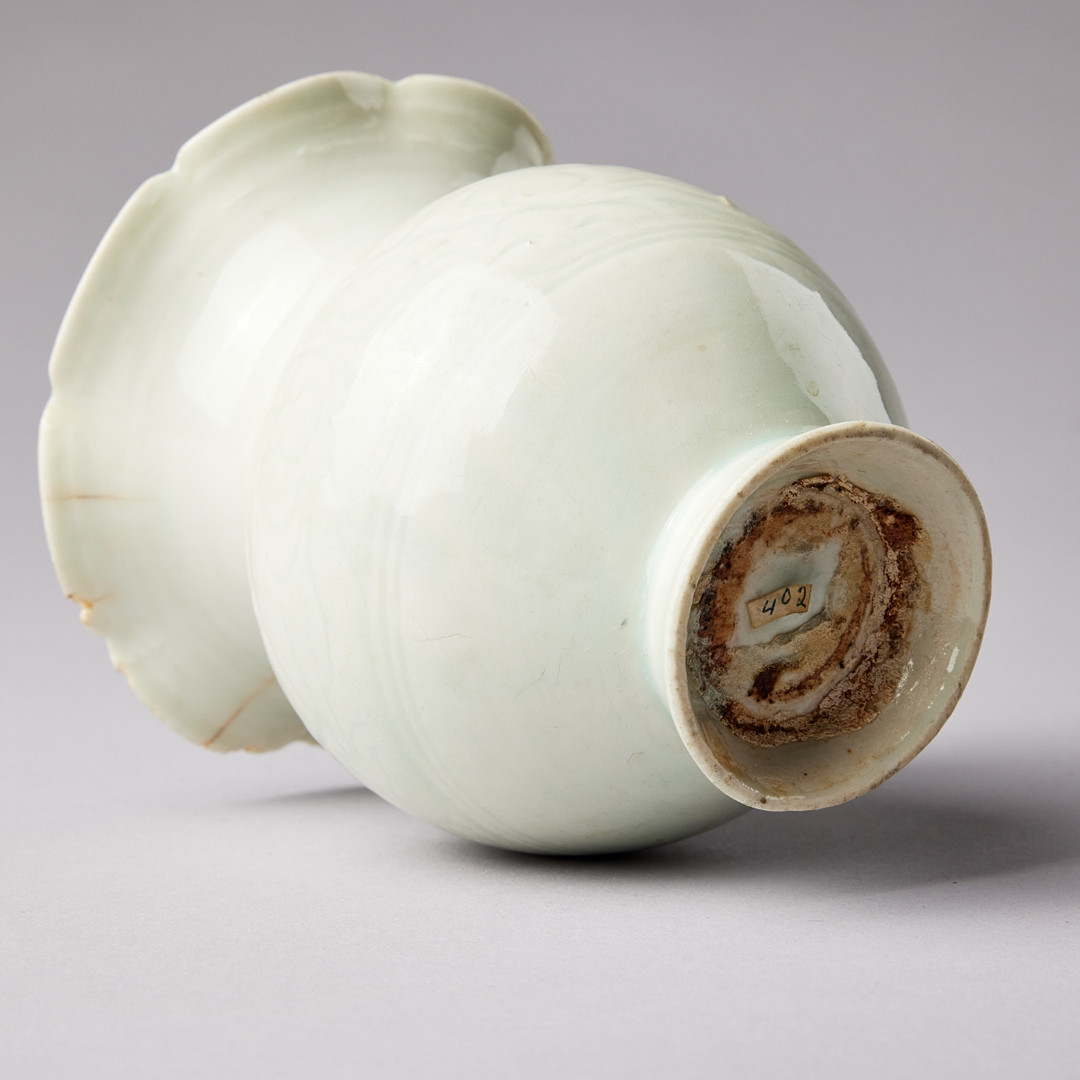 A QINGBAI CARVED BALUSTER VASE.