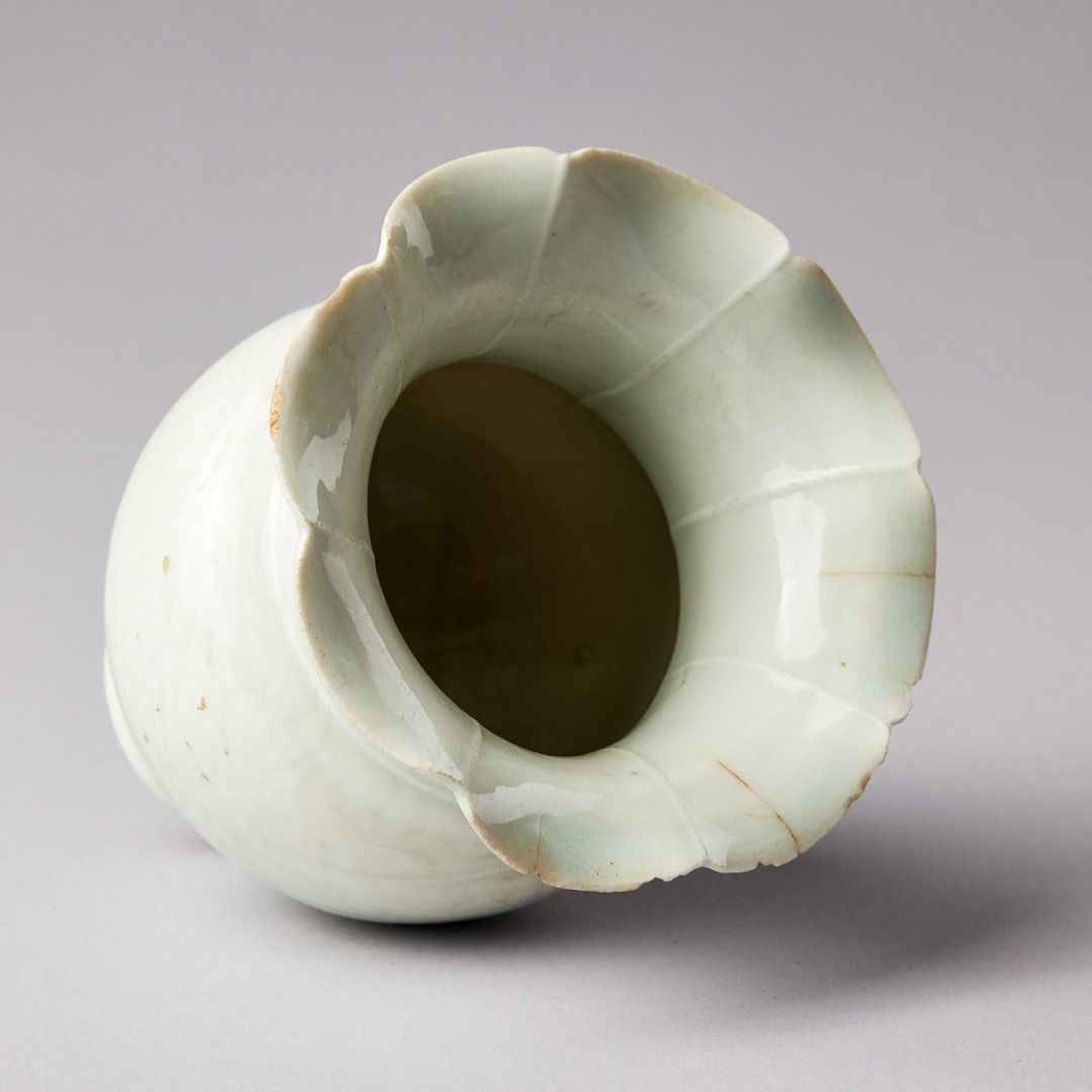 A QINGBAI CARVED BALUSTER VASE.