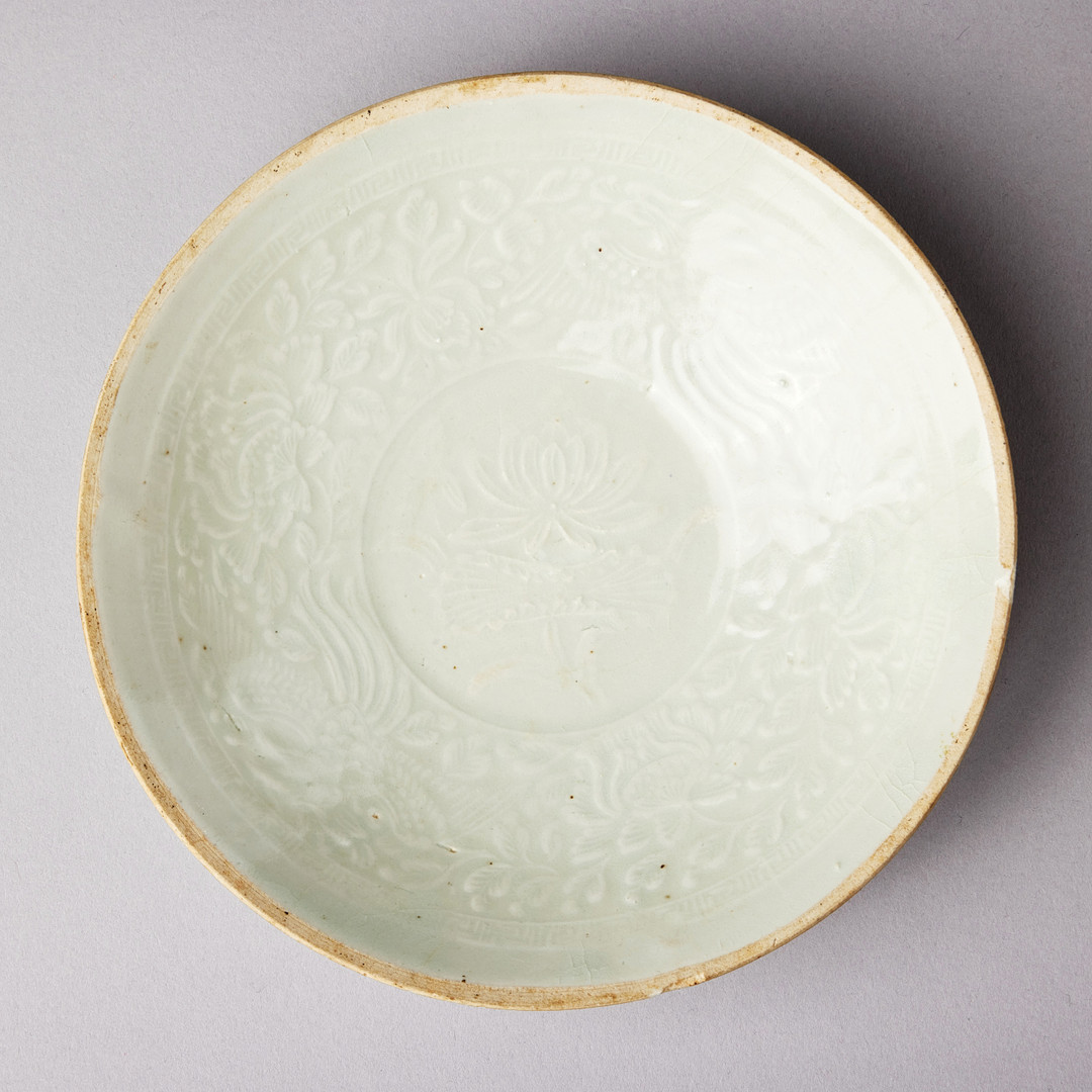 A MOULDED QINGBAI 'PHOENIX' BOWL.