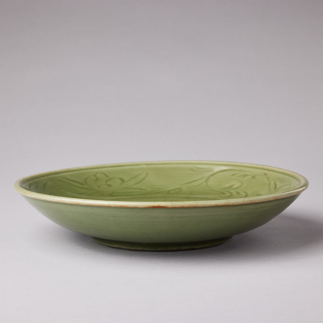 A CELADON CARVED AND IMPRESSED DISH.