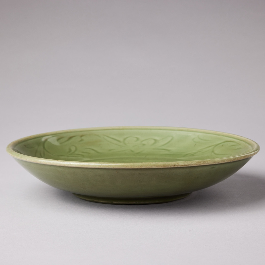 A CELADON CARVED AND IMPRESSED DISH.