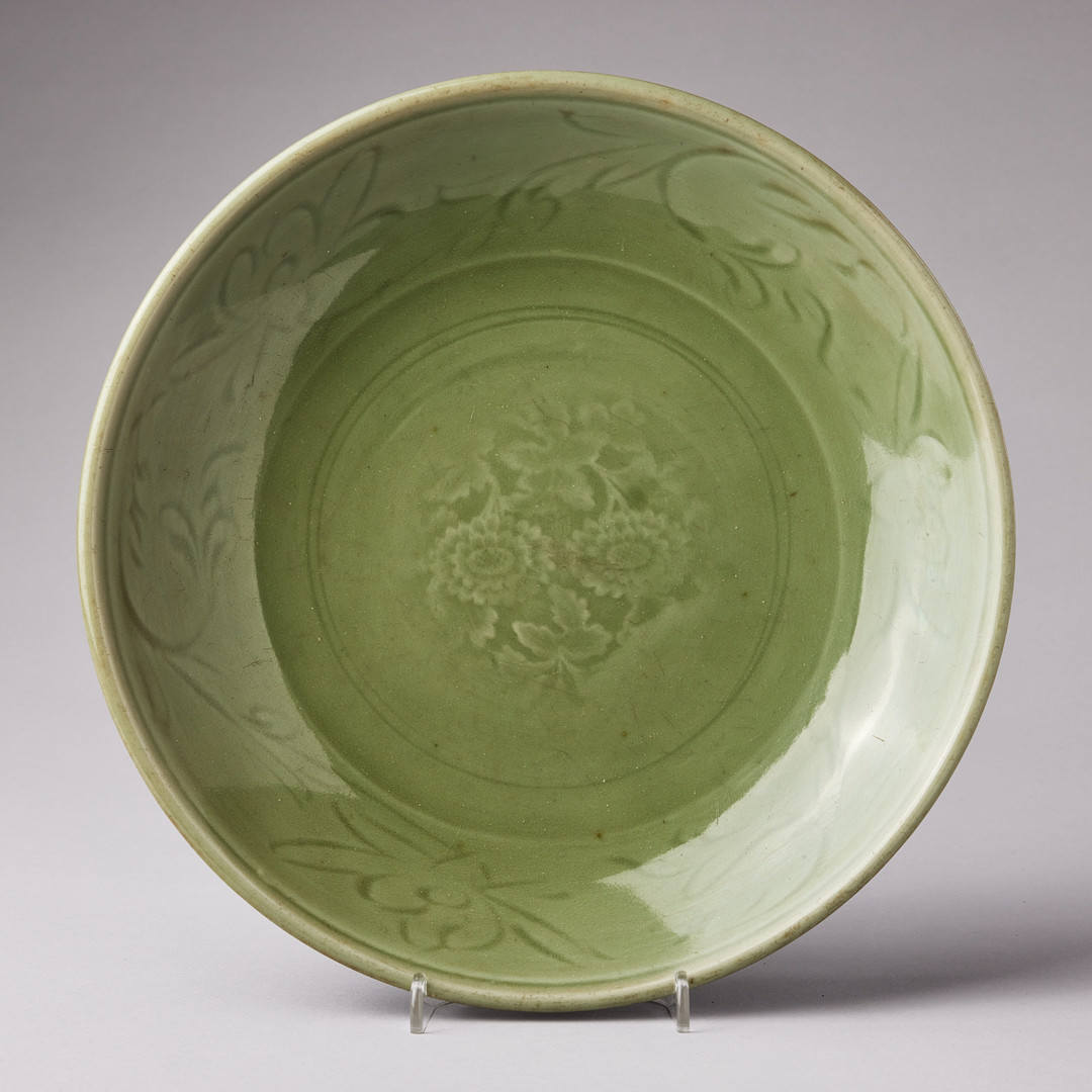 A CELADON CARVED AND IMPRESSED DISH.