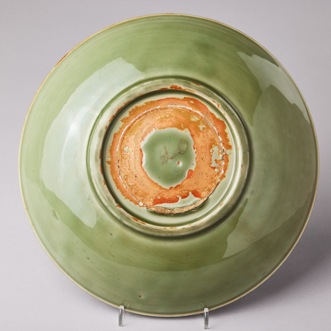A CELADON CARVED AND IMPRESSED DISH.