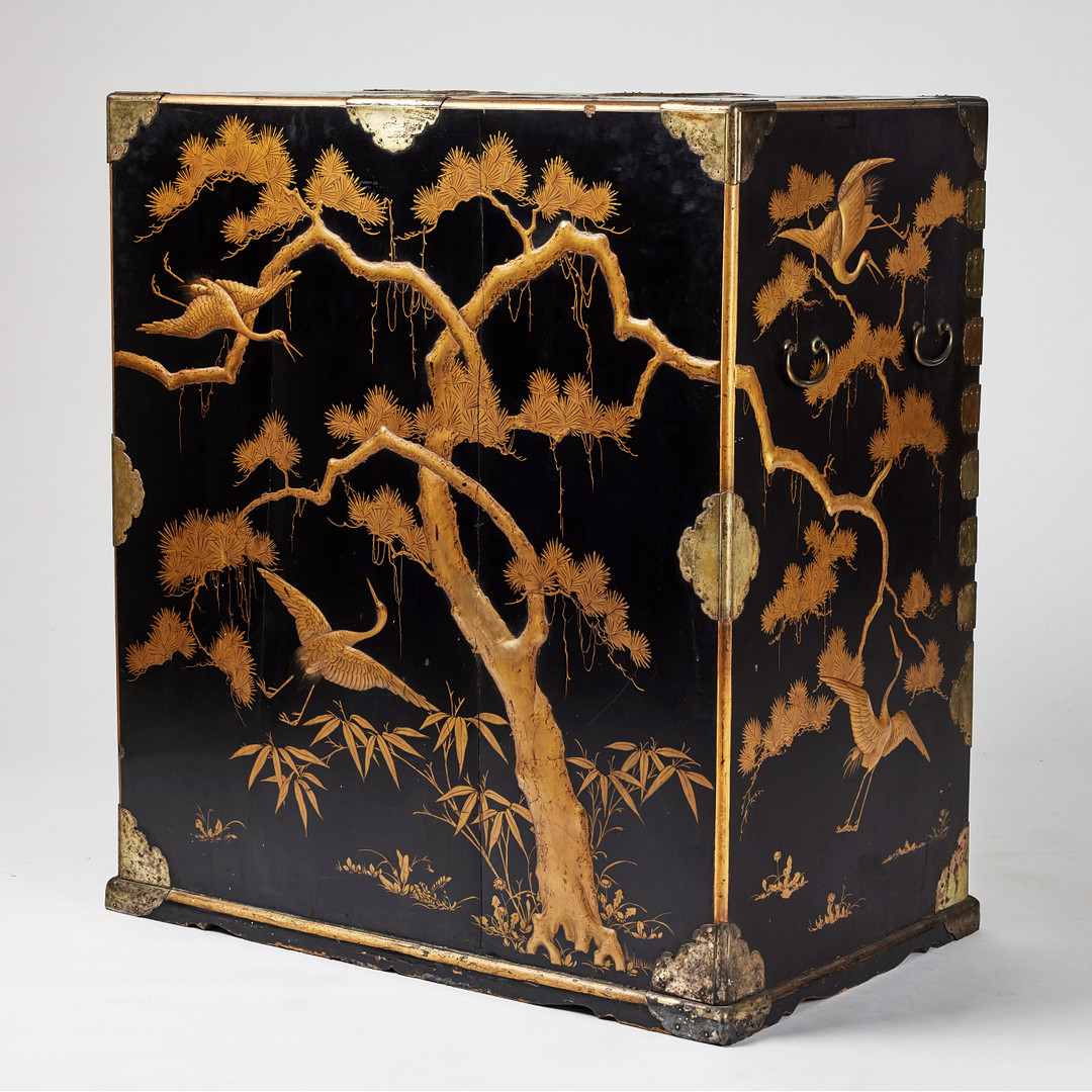 A RARE GOLD AND BLACK LACQUER 'TANSU' CABINET.