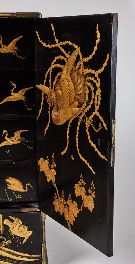 A RARE GOLD AND BLACK LACQUER 'TANSU' CABINET.