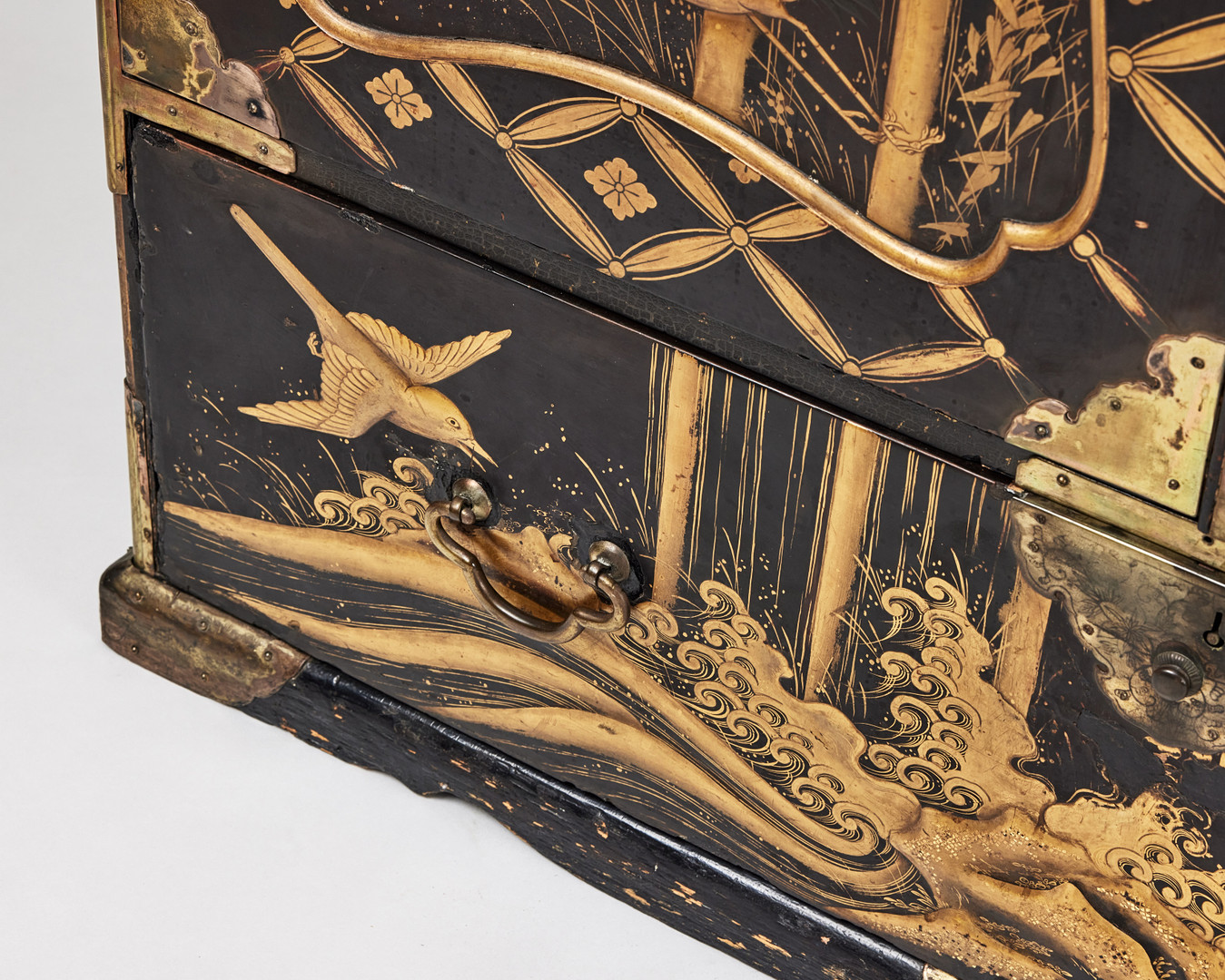 A RARE GOLD AND BLACK LACQUER 'TANSU' CABINET.
