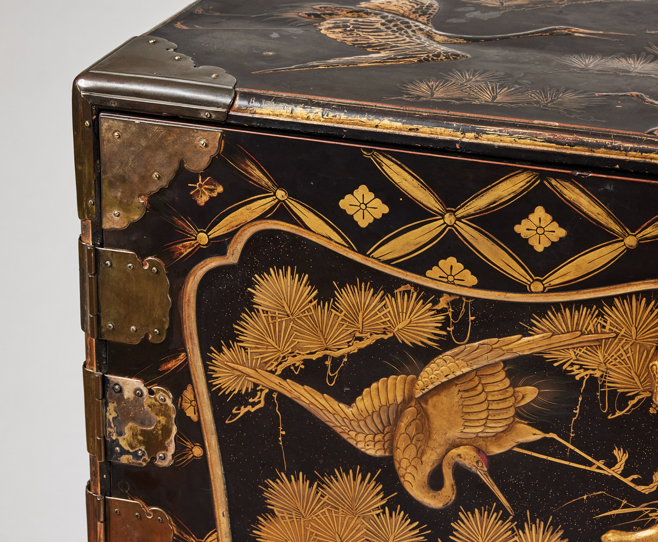A RARE GOLD AND BLACK LACQUER 'TANSU' CABINET.