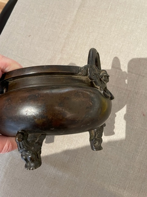A BRONZE TRIPOD CENSER.