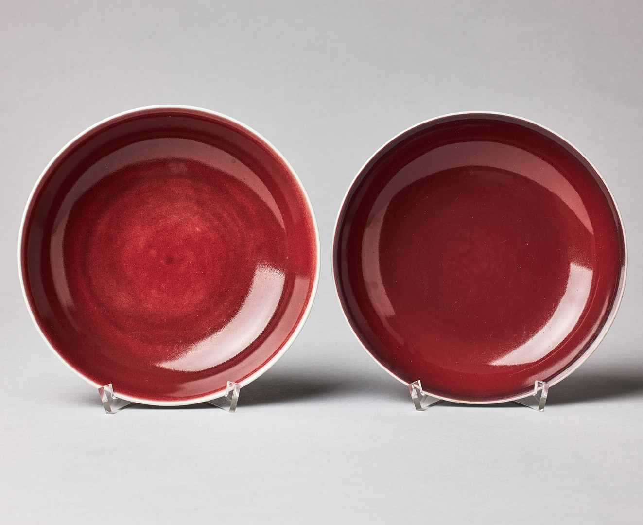 A SET OF THREE SANG-DE-BOEUF SAUCER DISHES.
