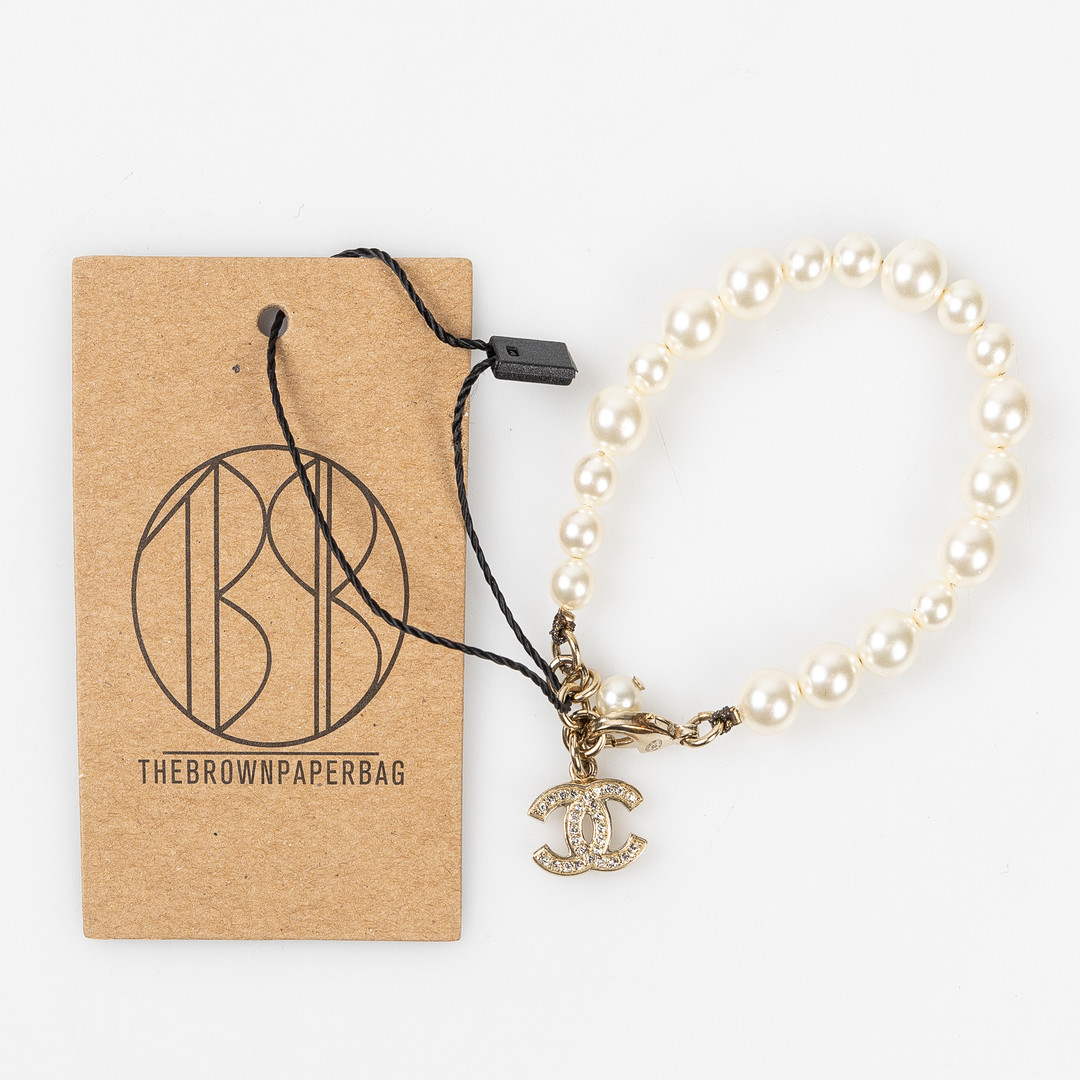 CHANEL, Armband, Costume jewelry, Faux Pearl och guldpläterat CC-berlock med strasstenar, 2011.