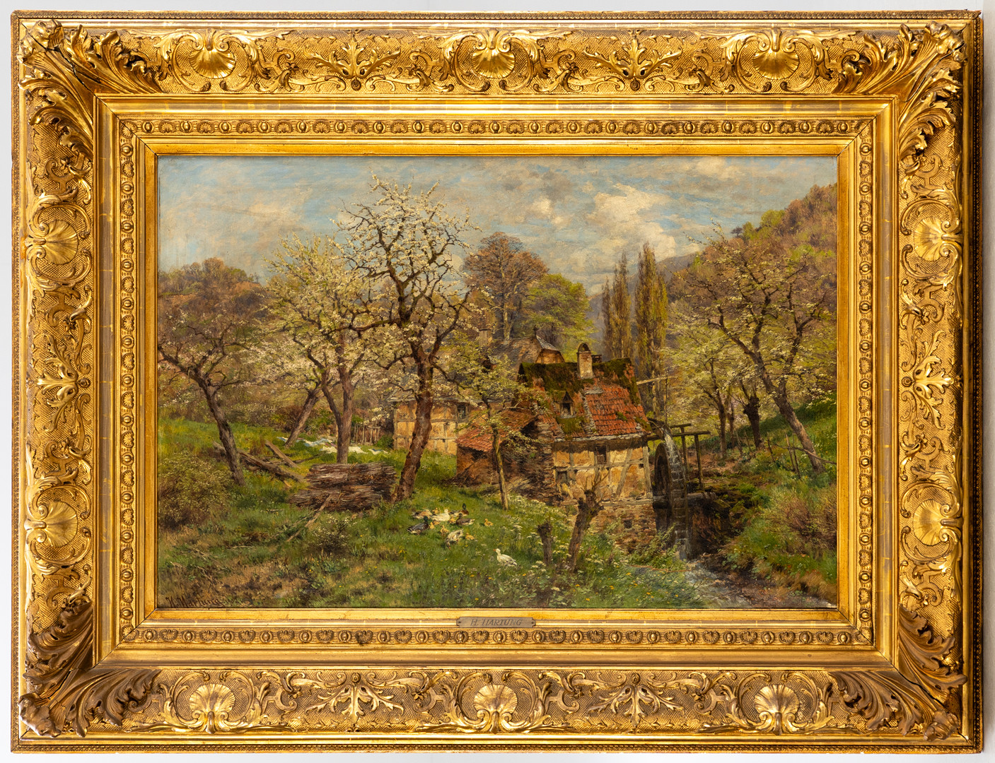 HEINRICH HARTUNG (1851-1919). Frühlingslandschaft mit Mühle.