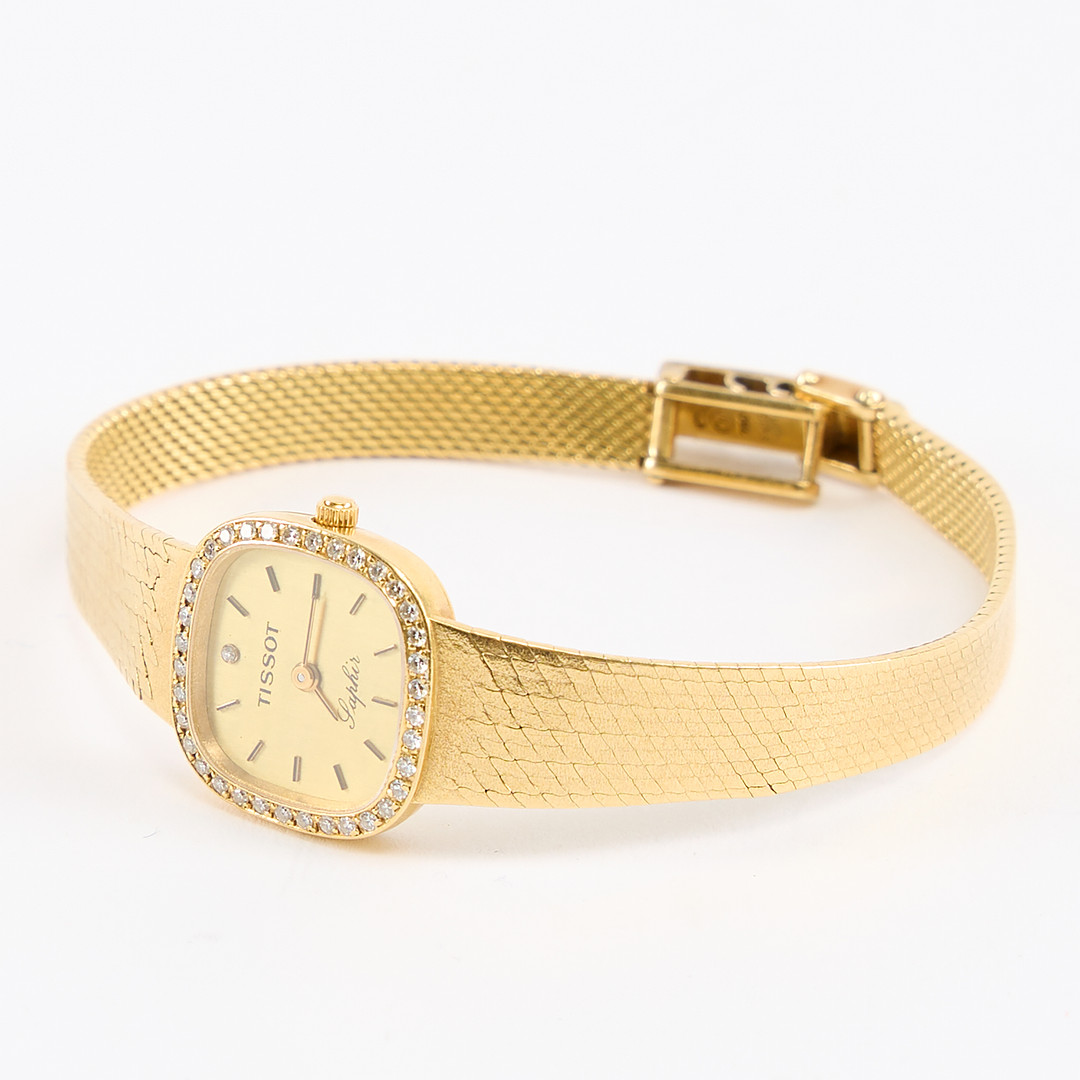 TISSOT. Damarmbandsur, Saphir, guld 18K.