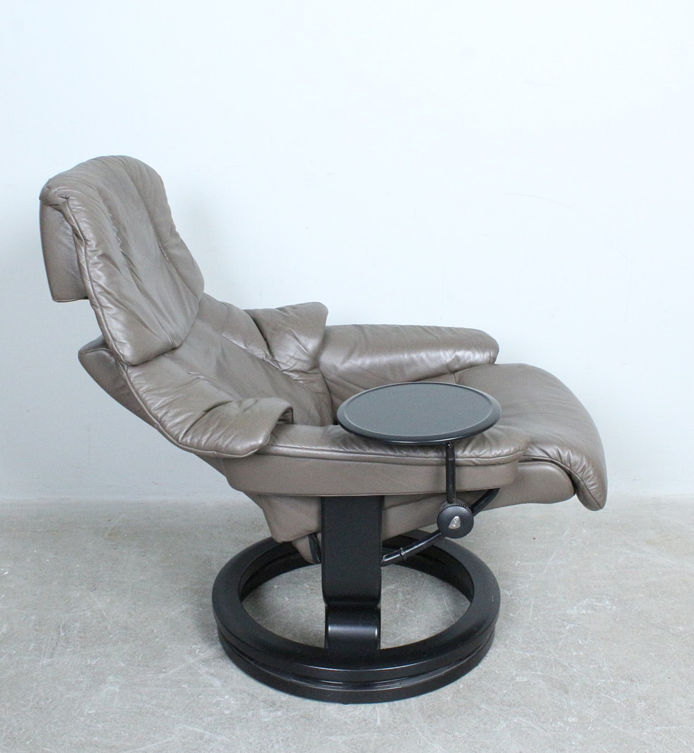 STRESSLESS / EKORNES. Loungesessel mit Ottomane aus Leder und Tisch, mit verstellbarer Sitz- und Drehfunktion, Norwegen.