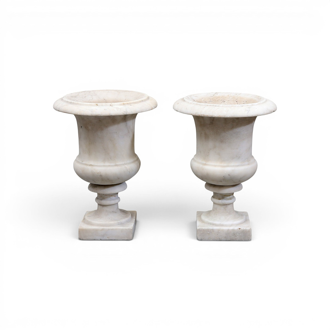 PAIR of Medici-style marble urns, from the early 20th century.