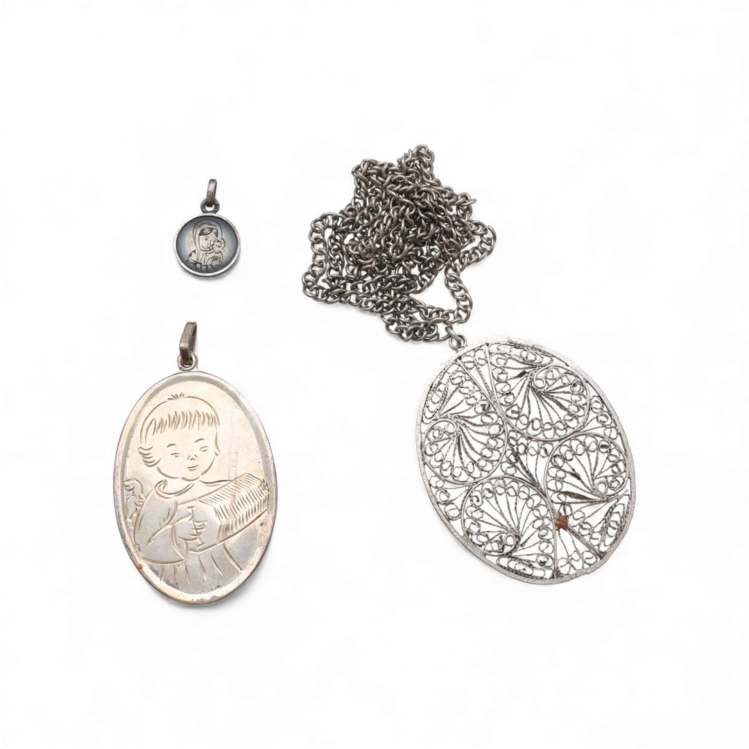 Two devotional medals in silver and a pendant with chain in metal, second half of the 20th Century.