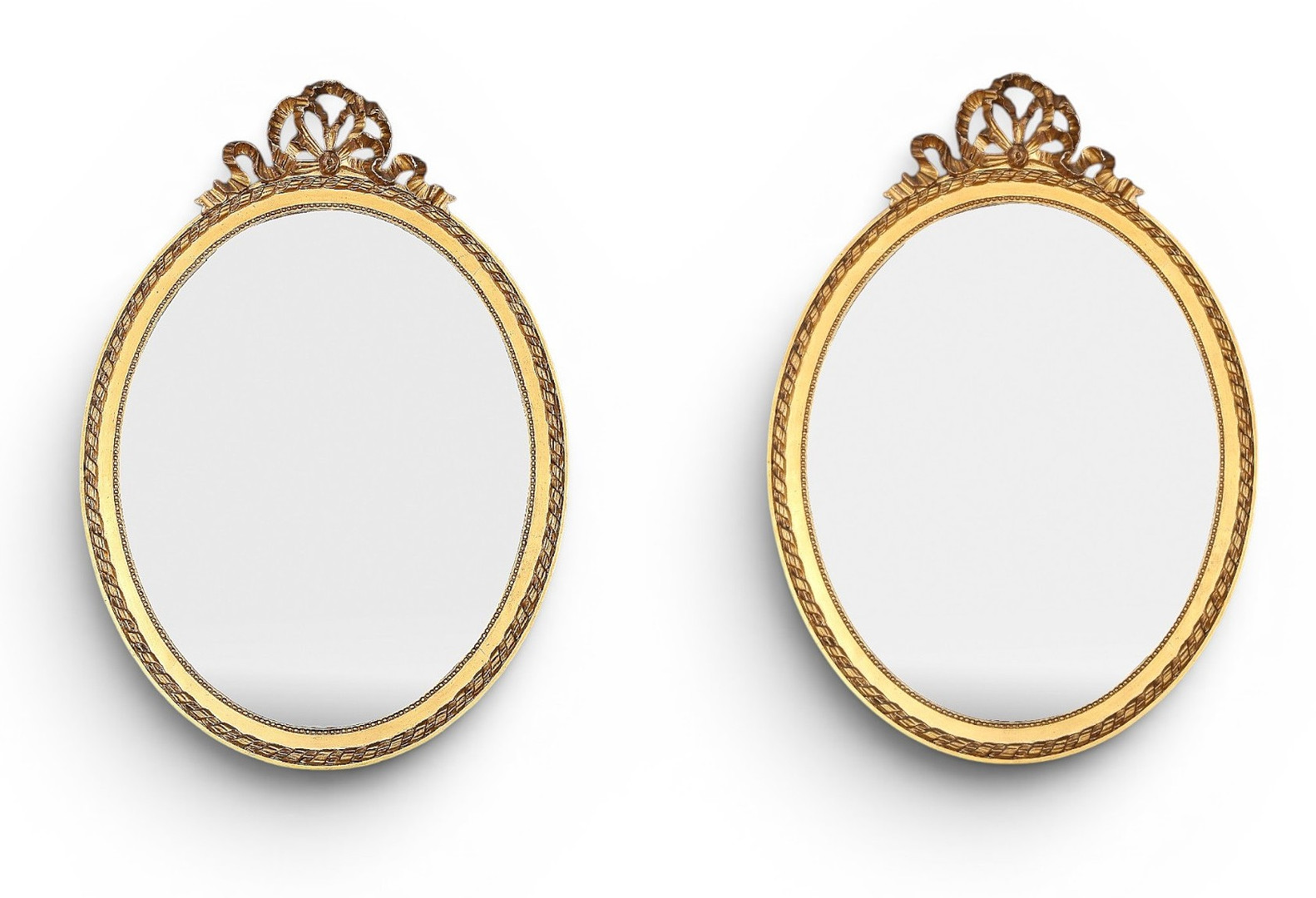 Pair of oval mirrors with Louis XVI style frames in gilt wood and stucco, early decades of the 20th Century.