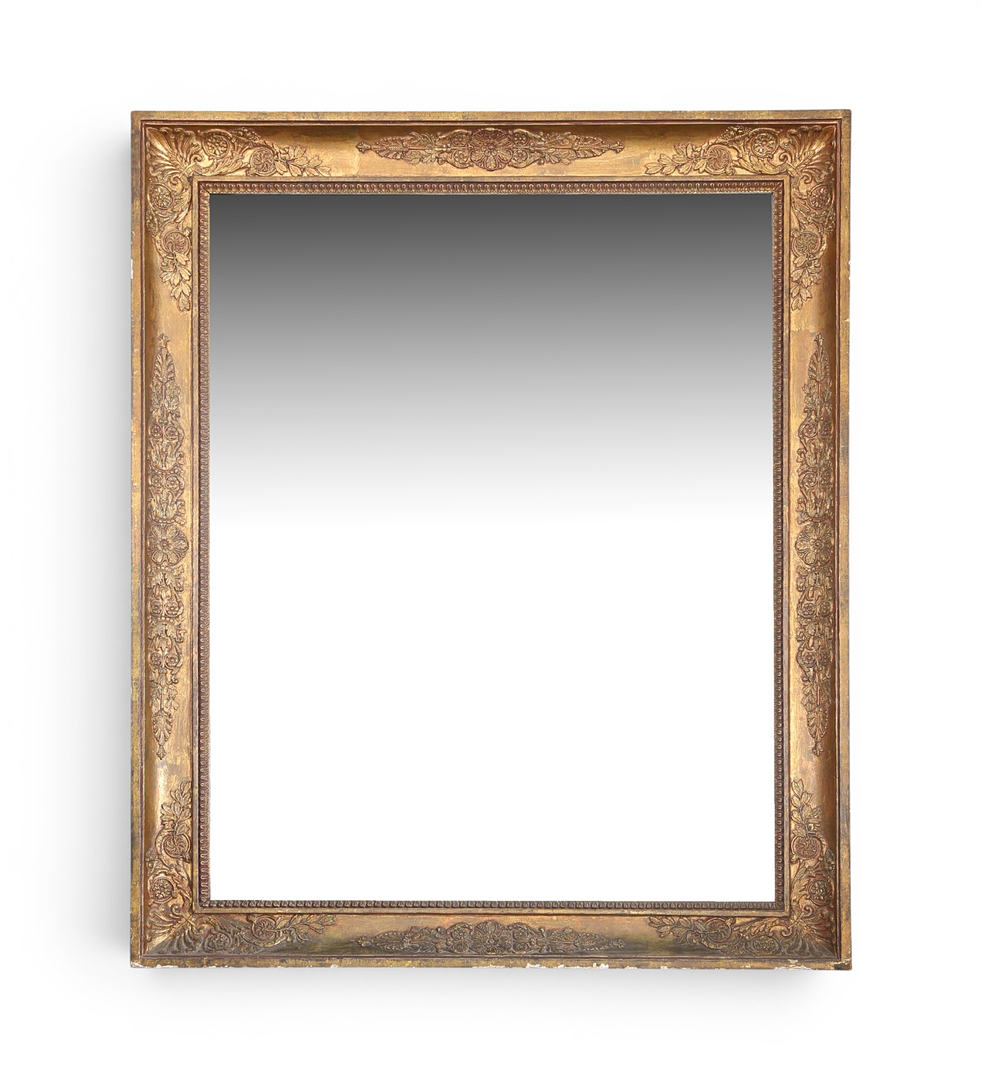 Mirror with Empire frame in stuccoed and gilt wood, 19th Century.
