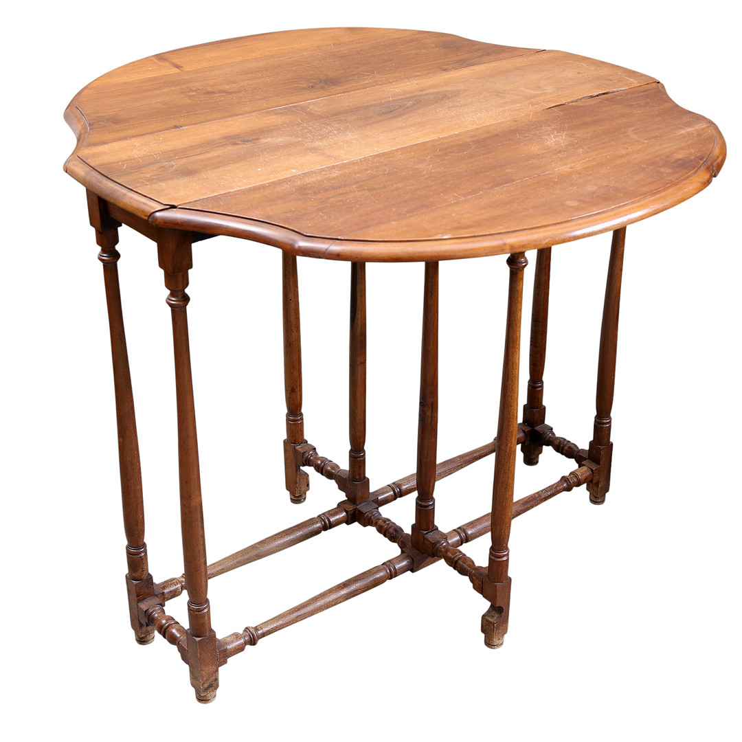 A winged table, likely English, made of stained walnut, from the 20th century.