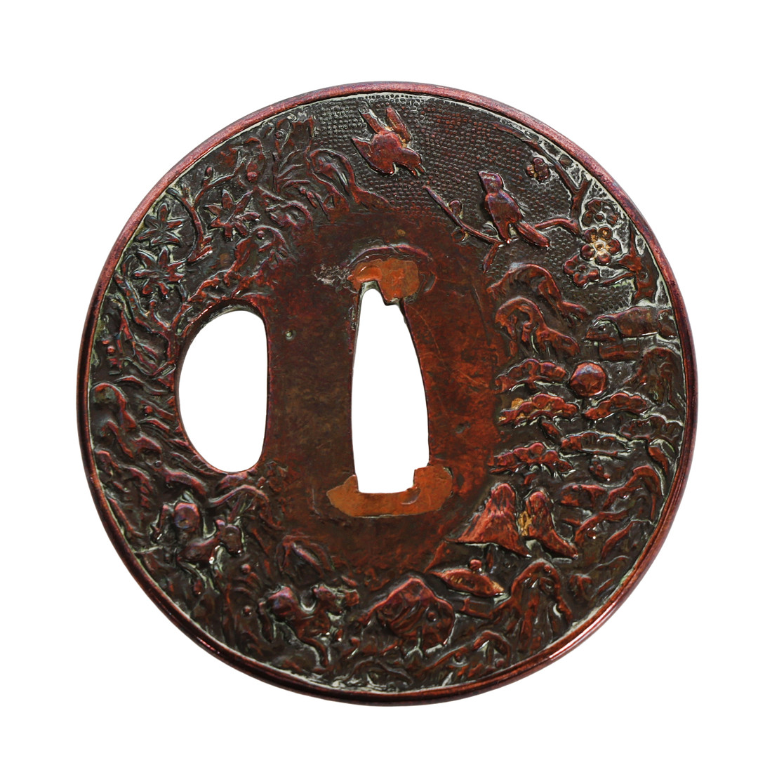 A JAPANESE COPPER TSUBA GUARD.