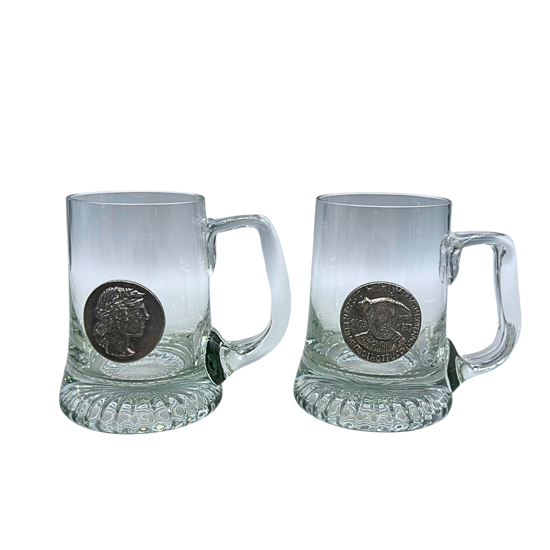 ZWEI BIERKRÜGE AUS GLAS MIT RELIEFDEKOR.