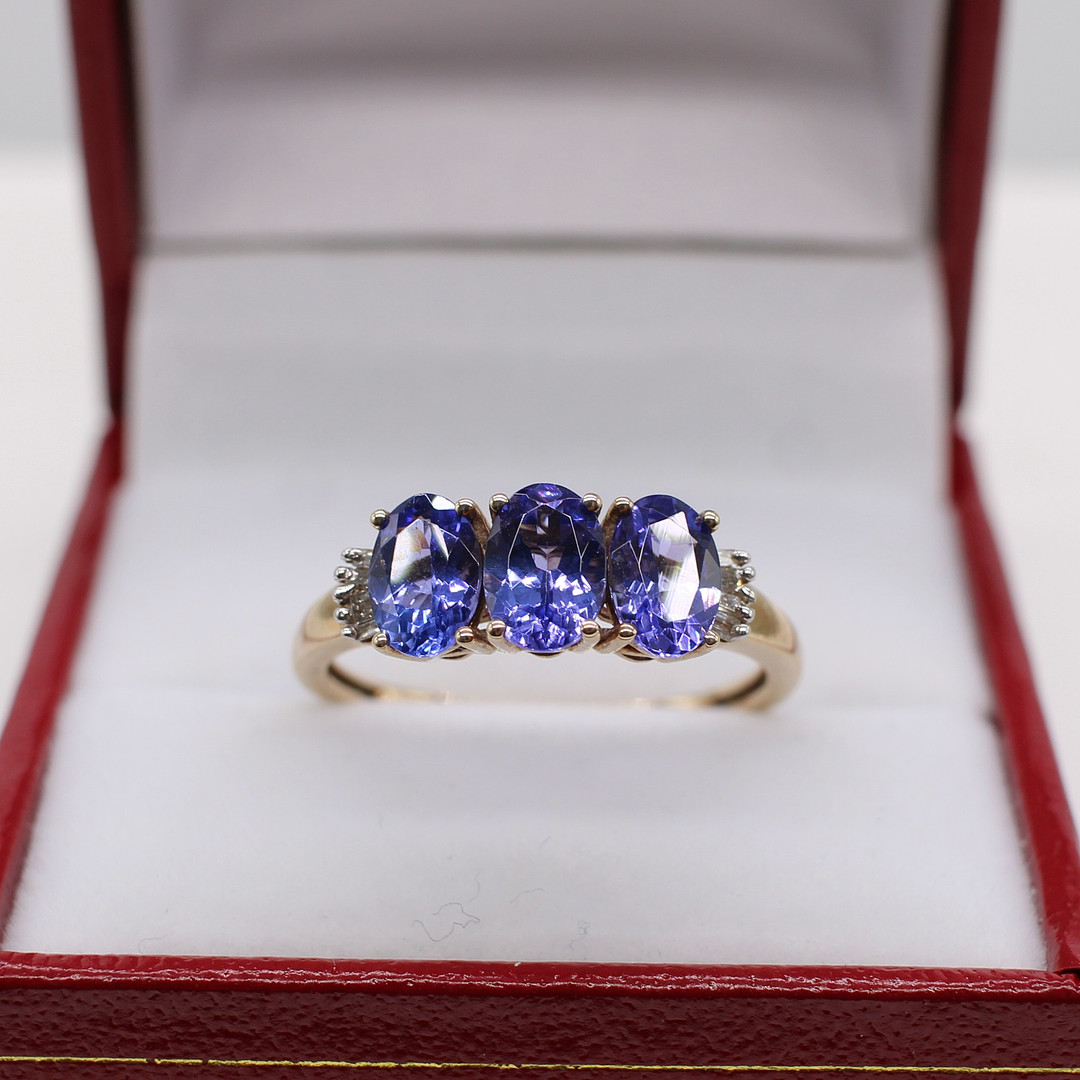 TANZANITE & DIAMOND TRILOGY RING.