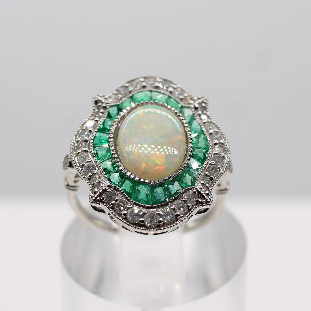 EMERALD, DIAMOND & OPAL RING.