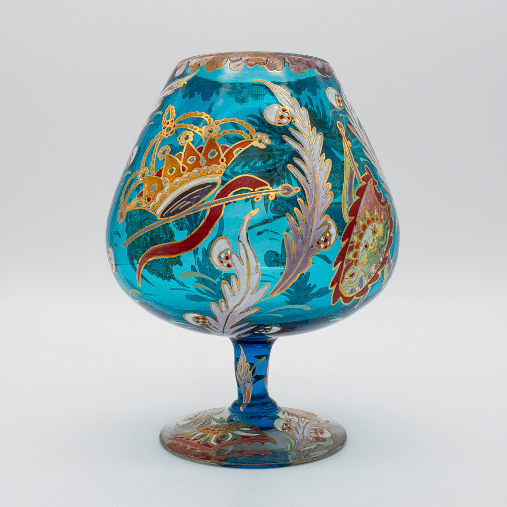 MARIANO ROYO CORTÉS. GLASBECHER IN BLAUEM FARBTON UND MIT TRANSLUZENTEM FUSS, VERZIERT MIT EMAILLIERTEN HERALDISCHEN UND RITTERLICHEN MOTIVEN, SIGNIERT ROYO AM FUSS.