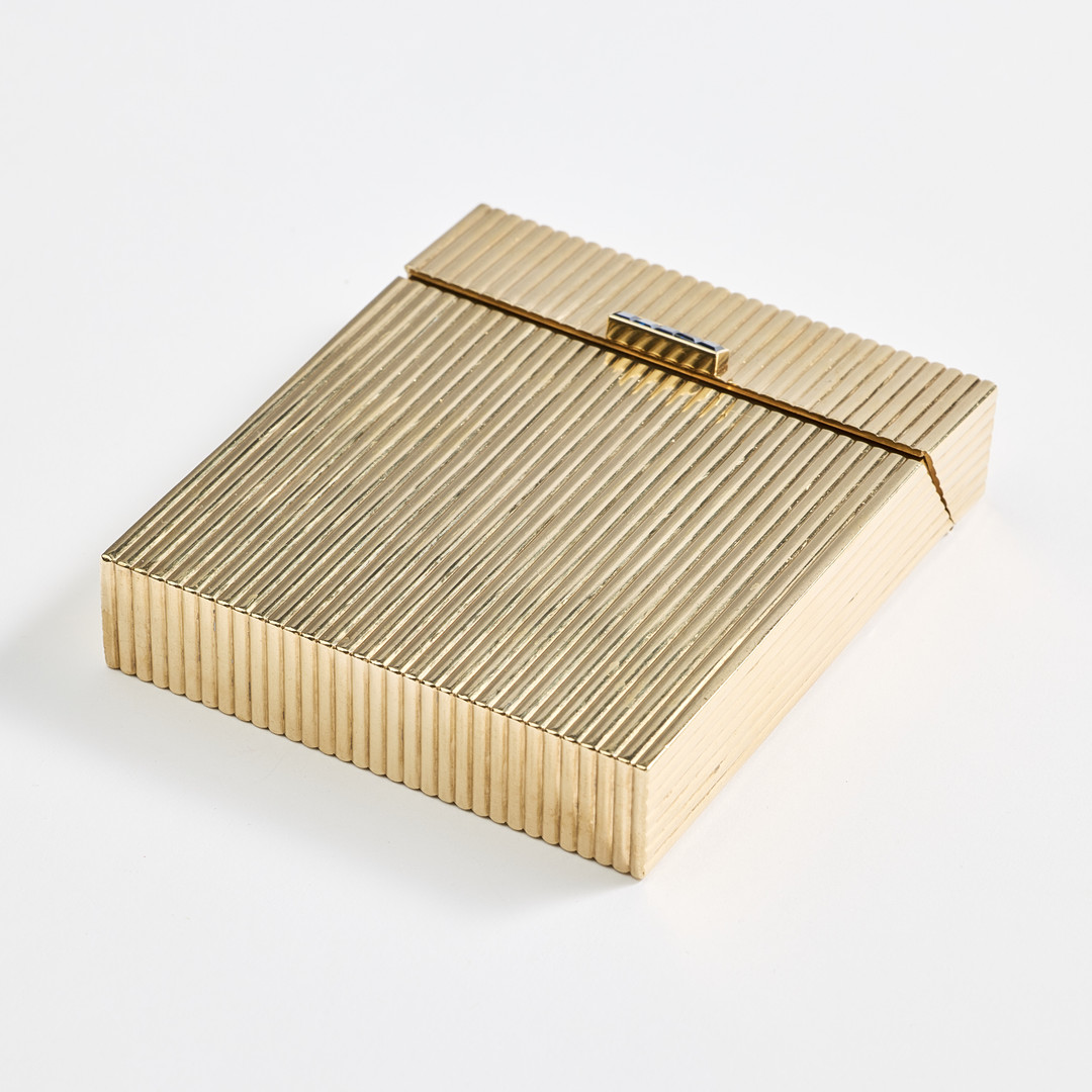 CARTIER. A 9K gold and sapphire cigarette case, London 1972.