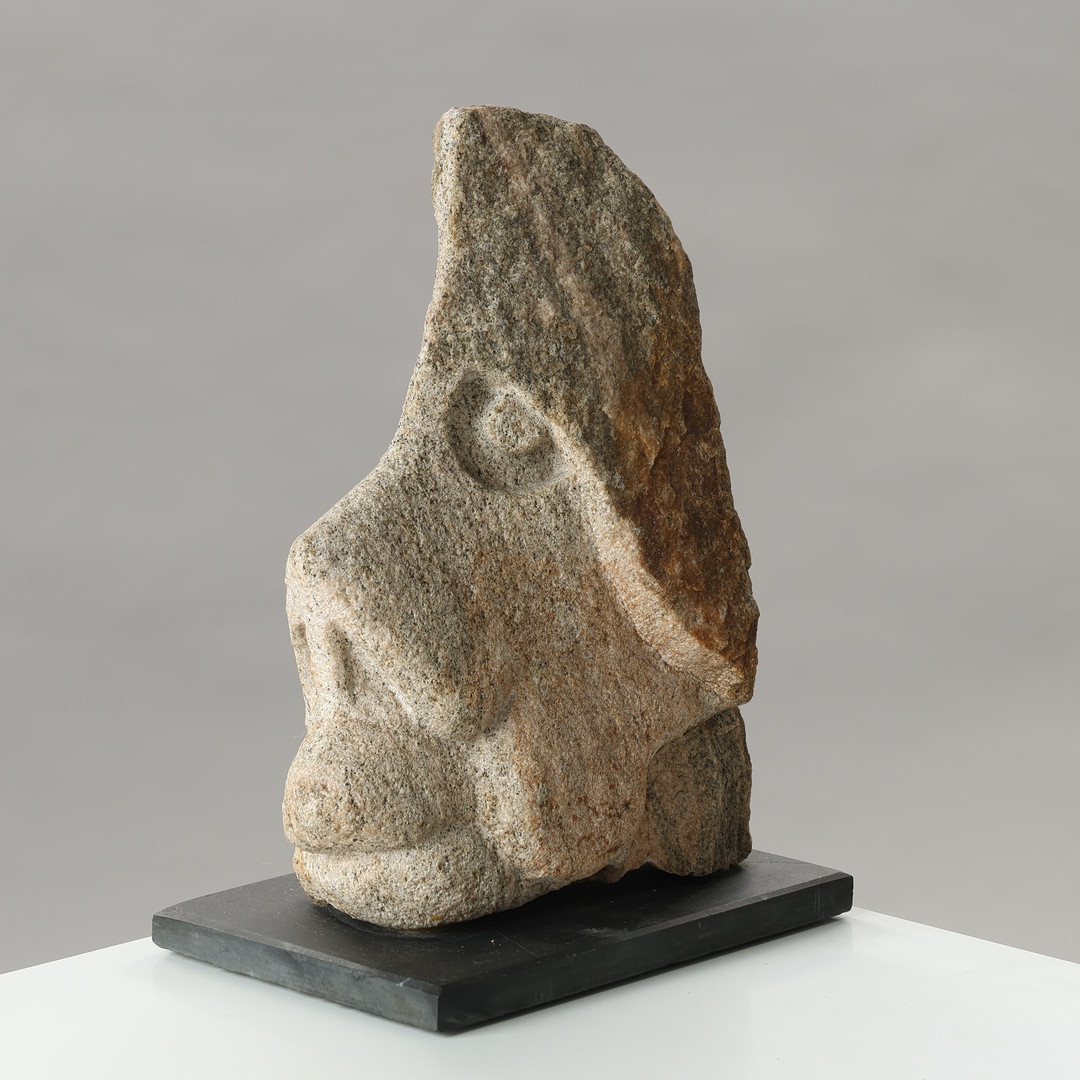 Signed sculpture in the form of a grotesque head carved in stone, unknown Danish sculptor, second half of the 20th century.
