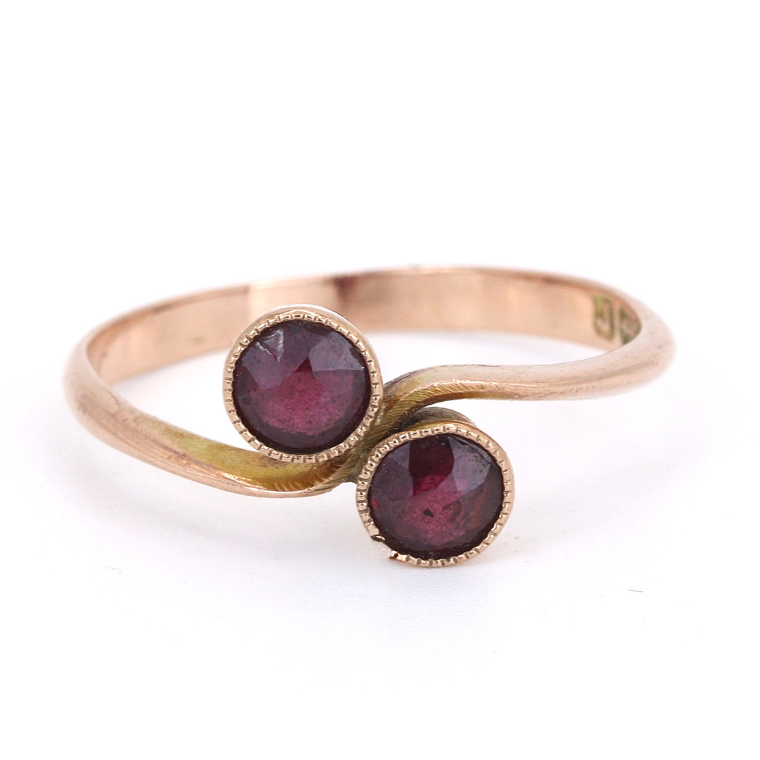9CT ROSE GOLD RUBY CROSSOVER RING.