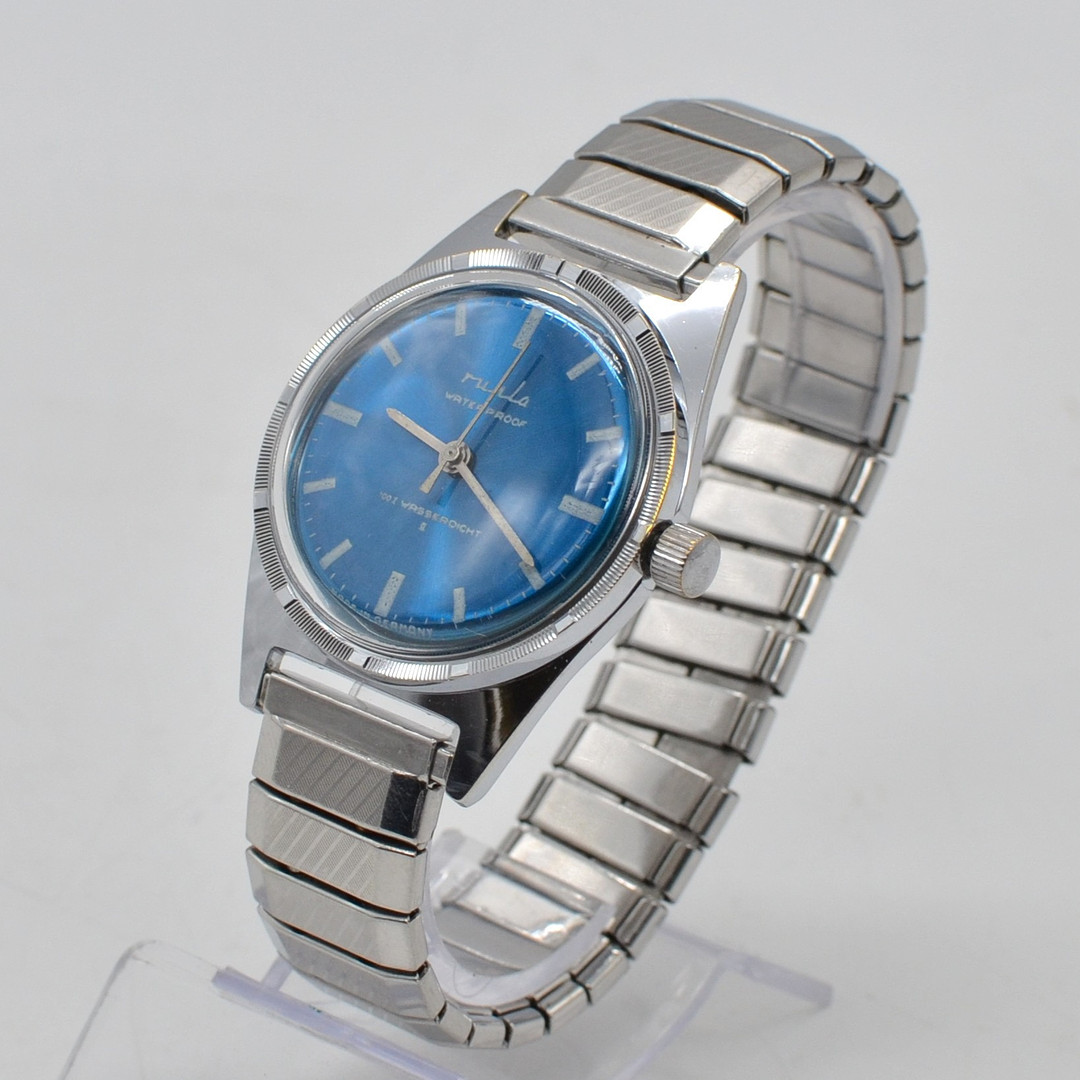 RUHLA, ARMBANDUHR, WATERPROOF, BLAUES ZIFFERBLATT, GEHÄUSE UND FLEXARMBAND AUS EDELSTAHL, MIT HANDAUFZUG, DEUTSCHLAND, UM 1969.