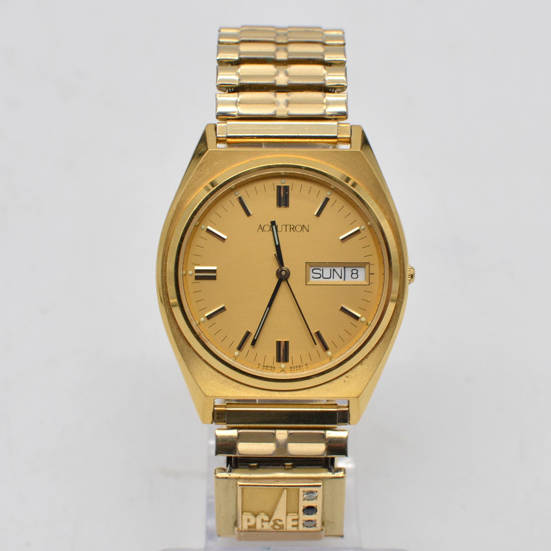 BULOVA ACCUTRON (92561), ARMBANDUHR MIT BRILLANT & SAPHIR, PG&E LOGO, VERGOLDETES GEHÄUSE UIND FLEXBAND, 1996.