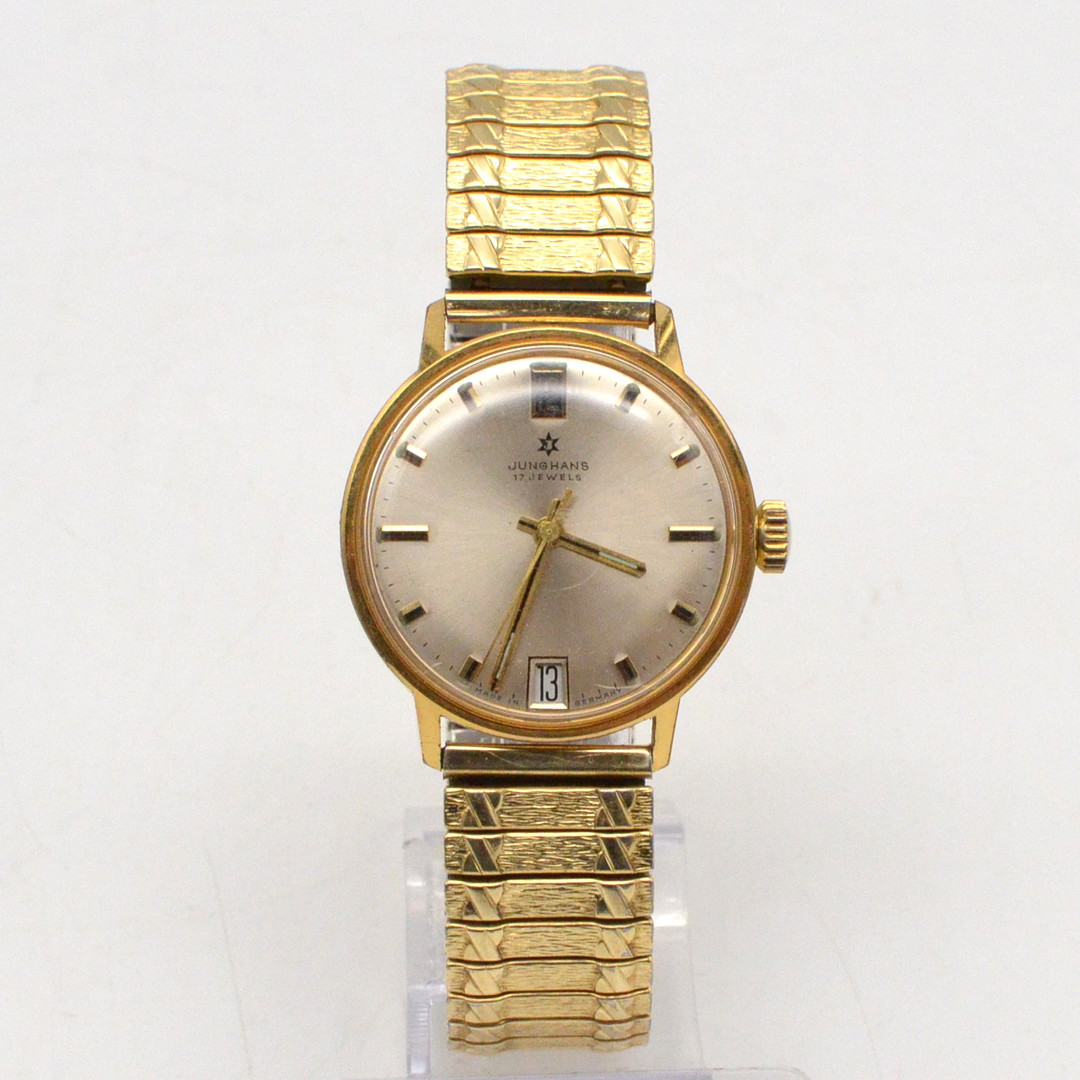JUNGHANS, 17 JEWELS, HERRENAMBANDUHR AUS DEN 1970ER JAHREN, HANDAUFZUG, VERGOLDET, DAYDATE, FLEXBAND MIT STRUKTUROBERFLÄCHE.