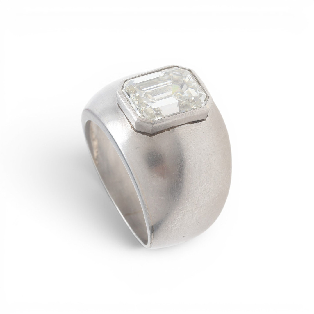 Bombé ring with an emerald cut diamond.