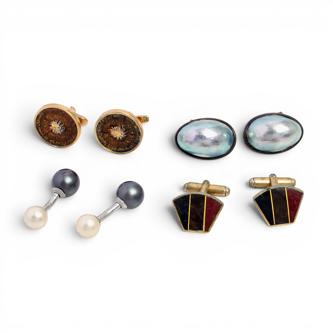 Four pairs of silver and metal cufflinks.