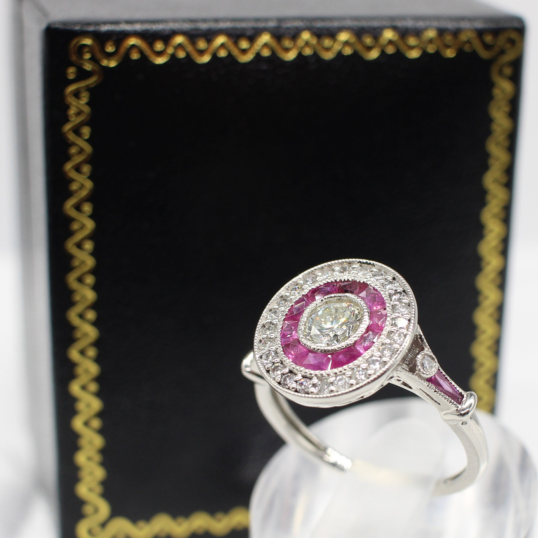DIAMOND & RUBY TARGET RING IN PLATINUM.