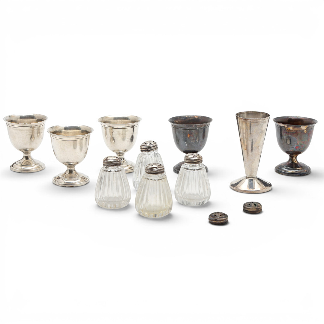 Set of egg cups and salt cellars in metal and silver, 20th Century.