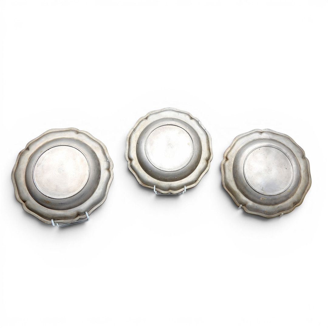 Set of three mitred dishes and a pair of German pewter dishes, 18th and 19th centuries.