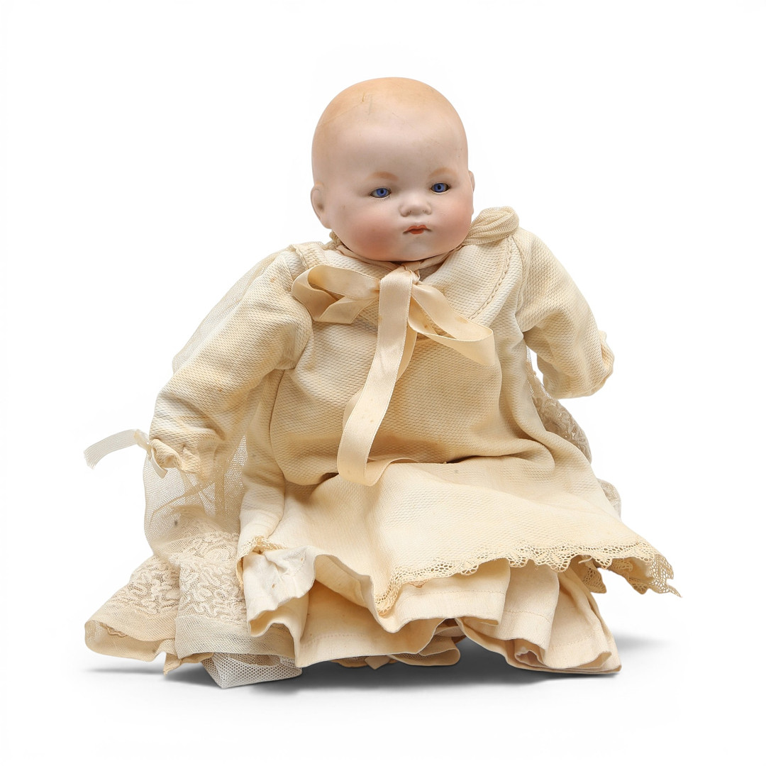 German baby doll with porcelain head and christening gown, early 20th Century.
