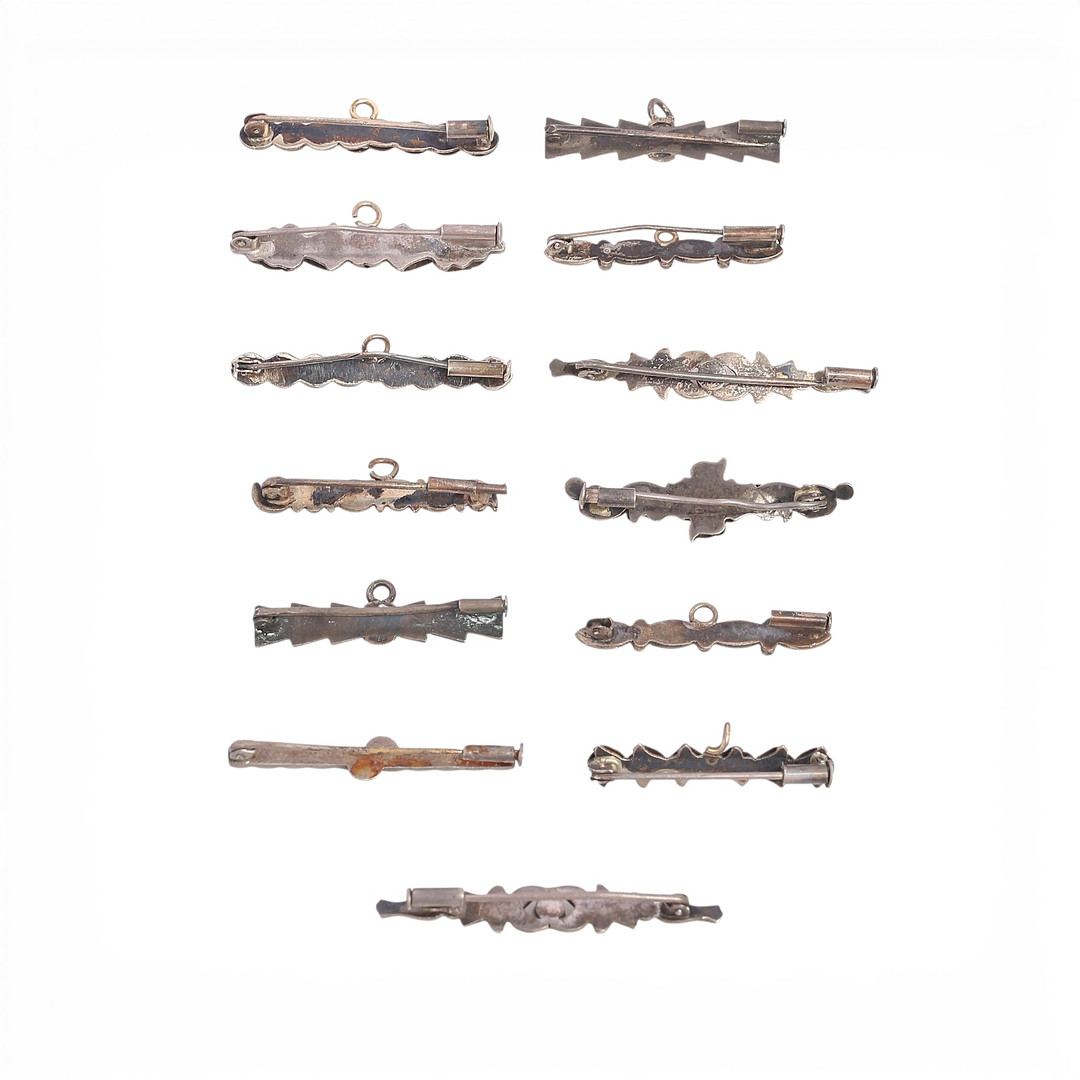 Thirteen silver baptism or communion brooches/pins, first half of the 20th Century.