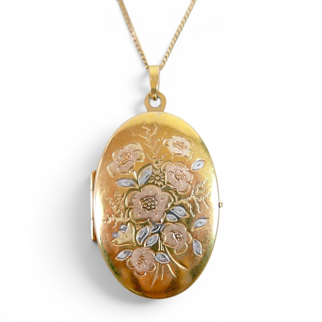 A 9CT YELLOW GOLD LOCKET ON CHAIN.