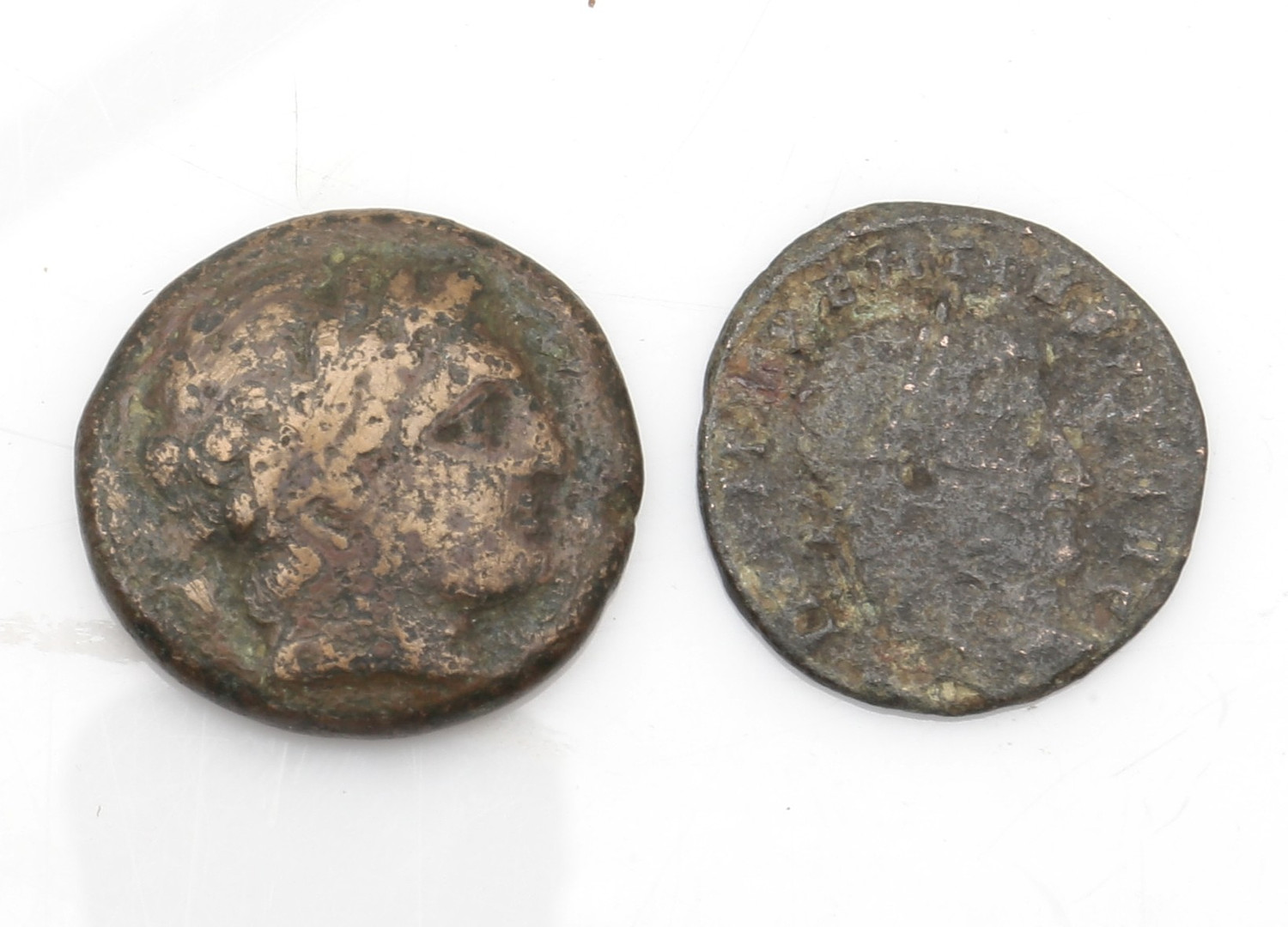 Two Roman coins: quadrans (225-217 BC) and nummus (305-307).