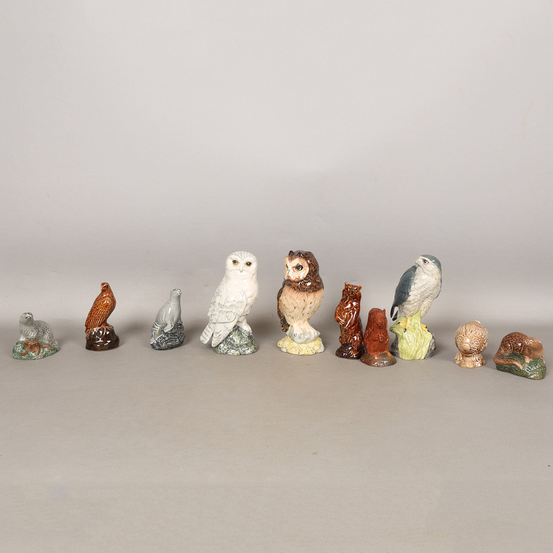 A COLLECTION OF ROYAL DOULTON AND BESWICK WHISKY DECANTERS (10).
