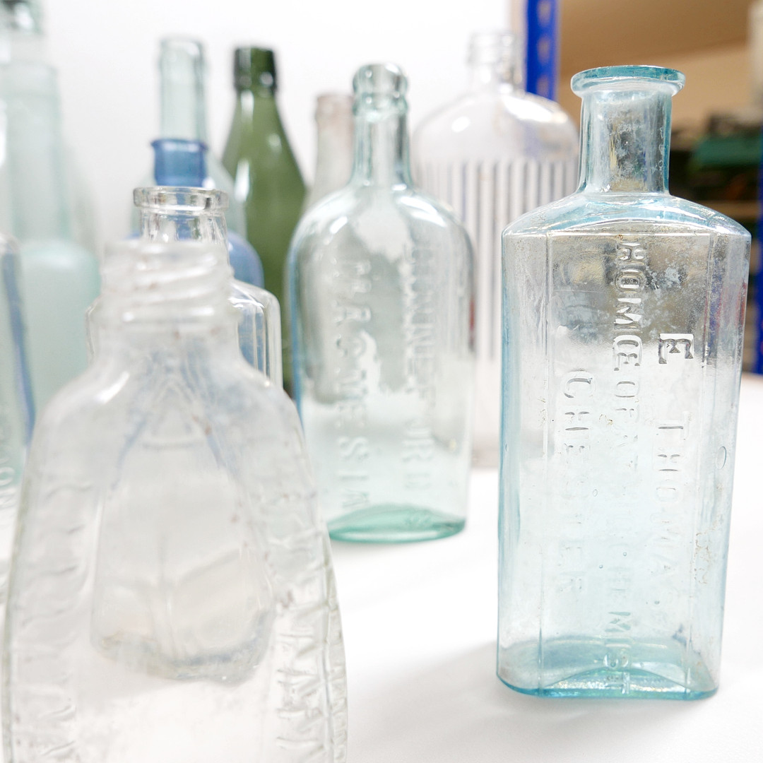THIRTY-SIX VINTAGE GLASS BOTTLES AND CONTAINERS.